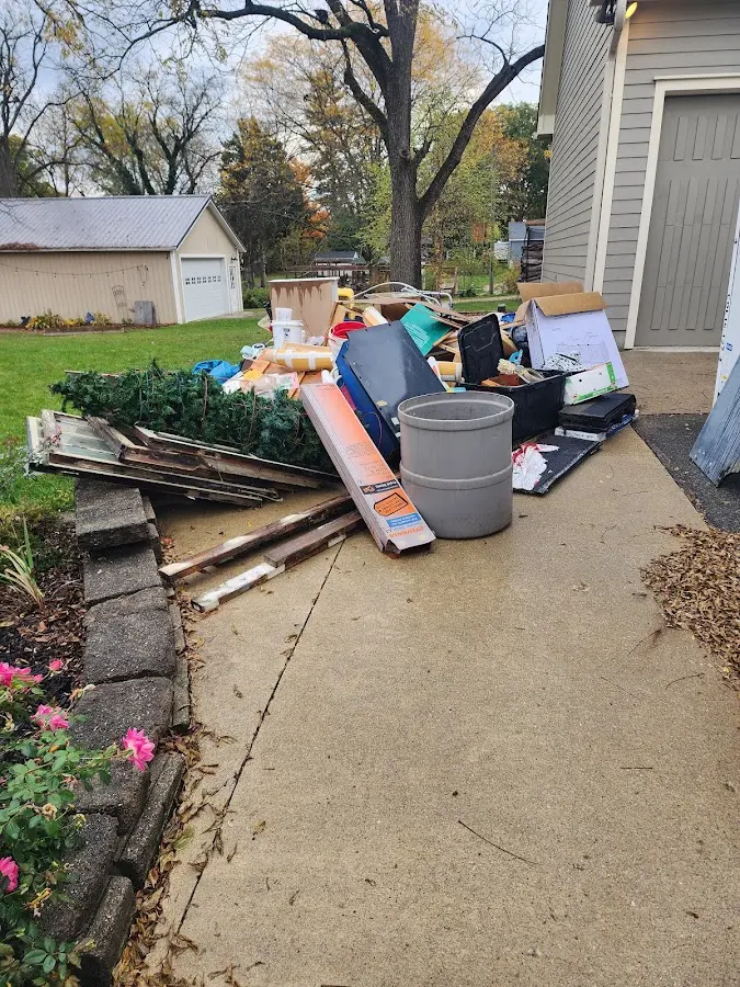 Dumpster being loaded with debris for Roofing Dumpster Rental in Temple